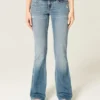 Blugi bootcut cu talie joasă, spălați mediu, cu aspect uzat Blugi bootcut cu talie joasă, spălați mediu, cu aspect uzat