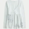 Bluză babydoll cu mâneci lungi și imprimeu grafic Bluză babydoll cu mâneci lungi și imprimeu grafic