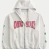 Boxy Hanorac cu glugă și fermoar cu grafică Ohio State University Buckeyes Boxy Hanorac cu glugă și fermoar cu grafică Ohio State University Buckeyes