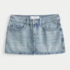 Fustă-pantalon mini din denim cu talie joasă, spălare medie și ținte Fustă-pantalon mini din denim cu talie joasă, spălare medie și ținte