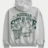 Hanorac cu glugă și fermoar, croi drept, cu grafică Michigan State University Spartans Hanorac cu glugă și fermoar, croi drept, cu grafică Michigan State University Spartans