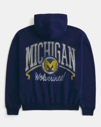 Hanorac cu glugă și fermoar, model boxy, cu imprimeu grafic Wolverines, Universitatea din Michigan Hanorac cu glugă și fermoar, model boxy, cu imprimeu grafic Wolverines, Universitatea din Michigan