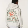 Hanorac cu glugă și imprimeu grafic Boxy Zip-Up University of Miami Hurricanes Hanorac cu glugă și imprimeu grafic Boxy Zip-Up University of Miami Hurricanes