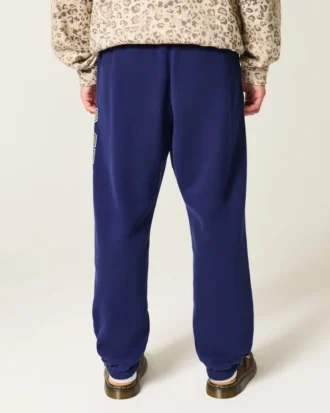 Pantaloni de jogging largi din fleece cu imprimeu Wolverines de la Universitatea din Michigan Pantaloni de jogging largi din fleece cu imprimeu Wolverines de la Universitatea din Michigan