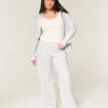 Pantaloni de trening largi cu imprimeu arc Pantaloni de trening largi cu imprimeu arc