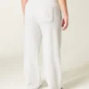 Pantaloni de trening largi cu imprimeu arc Pantaloni de trening largi cu imprimeu arc
