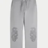 Pantaloni de trening largi cu imprimeu dublu cu șerpi Pantaloni de trening largi cu imprimeu dublu cu șerpi