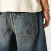 Pantaloni scurți din denim largi cu imprimeu șarpe Pantaloni scurți din denim largi cu imprimeu șarpe