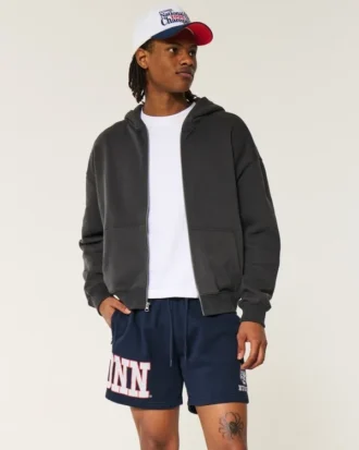 Pantaloni scurți din fleece până la jumătatea coapsei cu grafică UConn Huskies Pantaloni scurți din fleece până la jumătatea coapsei cu grafică UConn Huskies