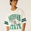 Tricou de fotbal cu grafică Michigan State University Spartans Tricou de fotbal cu grafică Michigan State University Spartans