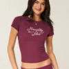 Tricou pentru bebeluși cu imprimeu Naughty But Nice Tricou pentru bebeluși cu imprimeu Naughty But Nice